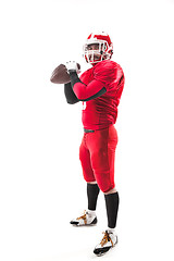 Image showing American football player posing with ball on white background