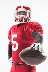 Image showing American football player posing with ball on white background