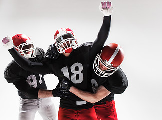 Image showing The three american football players posing on white background