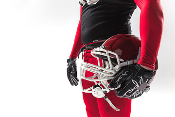 Image showing American football player posing with helmet on white background