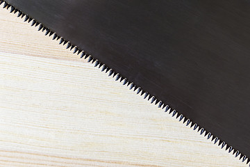 Image showing Hacksaw blade and wood plank texture