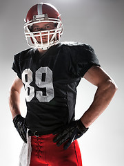 Image showing American football player posing with ball on white background