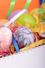 Image showing Arrangement of Gift Boxes in Wrapping Paper with Checkered Ribbons and Decorated Easter Eggs isolated on white background