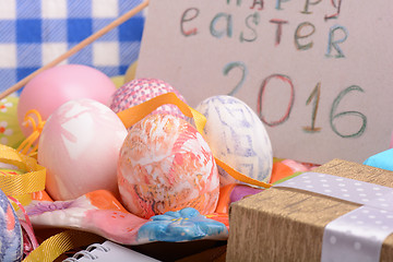 Image showing hand made eggs at a gift box, happy easter invitation card