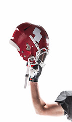 Image showing The hand of american football player with helmet on white background