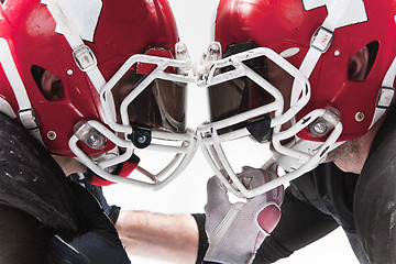 Image showing The two american football players fighting on white background