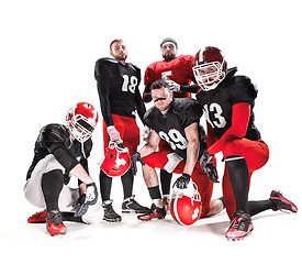 Image showing The five american football players posing with ball on white background