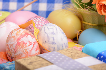 Image showing Arrangement of Gift Boxes in Wrapping Paper with Checkered Ribbons and Decorated Easter Eggs isolated on white background