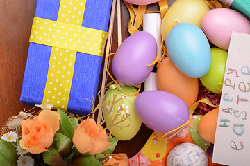 Image showing Arrangement of Gift Boxes in Wrapping Paper with Checkered Ribbons and Decorated Easter Eggs isolated on white background