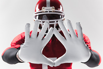Image showing The hands of american football player on white 
