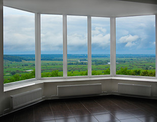 Image showing modern window of veranda with thundercloud landscape 