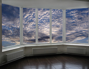 Image showing plastic windows overlooking the sunset with clouds
