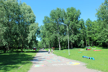 Image showing People have a rest in park with big trees