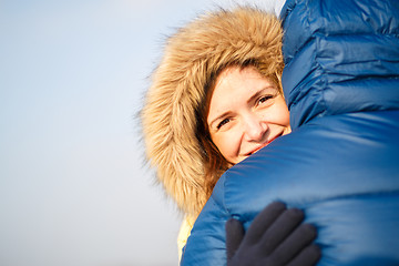 Image showing happy pair of male and female embracing ain winter outdoors