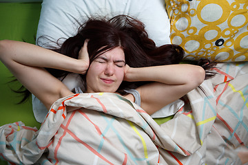 Image showing Tired woman sleeping on a bed at home