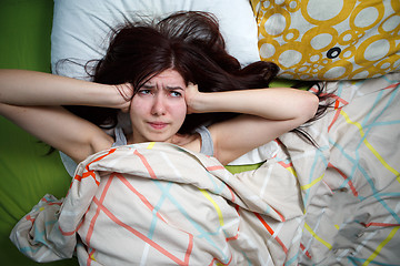 Image showing Tired woman sleeping on a bed at home