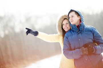 Image showing Young couple walking in a park. Winter season.