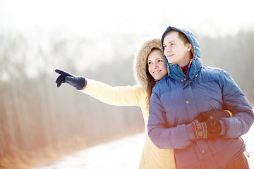 Image showing Young couple walking in a park. Winter season.