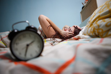 Image showing Woman with insomnia touching her head