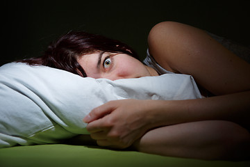 Image showing Young woman in bed  eyes opened suffering insomnia. Nightmare issues