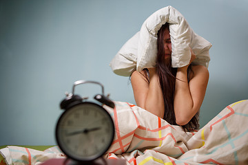 Image showing Woman with a pillow over head.