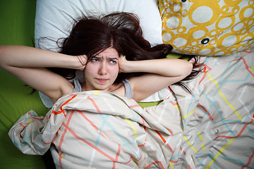 Image showing Tired woman sleeping on a bed at home