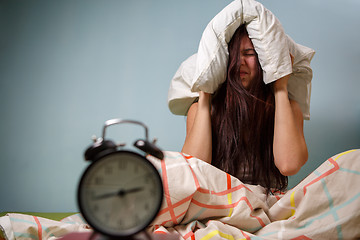 Image showing Woman with a pillow over head.