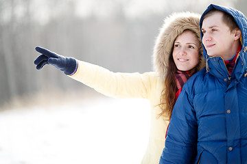 Image showing Young couple walking in a park. Winter season.