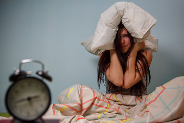 Image showing Woman with a pillow over head.