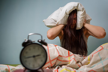 Image showing Woman with a pillow over head.