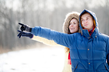 Image showing Young couple walking in a park. Winter season.