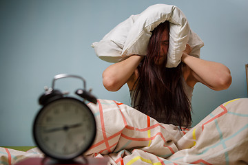 Image showing Woman with a pillow over head.