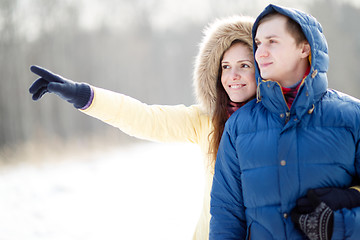 Image showing Young couple walking in a park. Winter season.