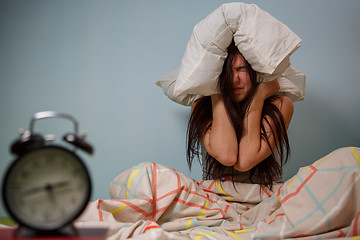 Image showing Woman with a pillow over head.