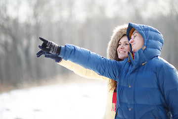 Image showing Young couple walking in a park. Winter season.