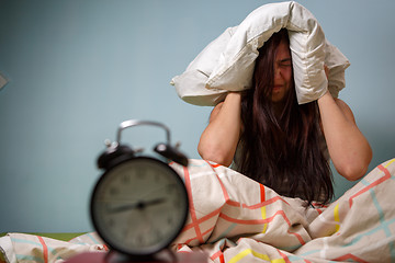 Image showing Woman with a pillow over head.