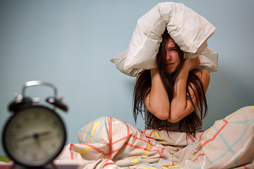 Image showing Woman with a pillow over head.