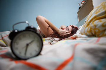 Image showing Woman with insomnia touching her head