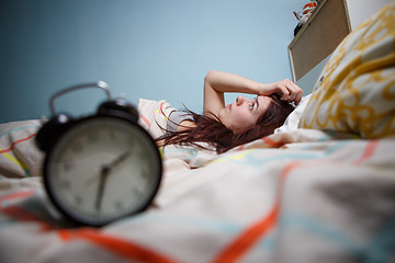 Image showing Woman with insomnia touching her head