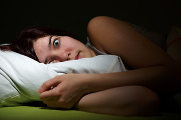 Image showing Young woman in bed  eyes opened suffering insomnia. Nightmare issues