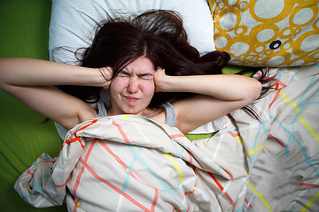 Image showing Tired woman sleeping on a bed at home