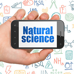 Image showing Science concept: Hand Holding Smartphone with Natural Science on display