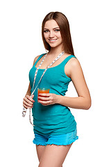 Image showing Happy teen girl holding a glass of carrot juice