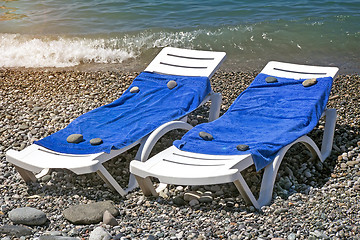 Image showing Two sun loungers for relaxing by the sea.