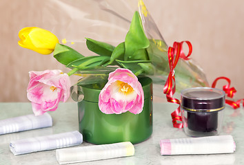 Image showing Cosmetics for body and hair and flowers.