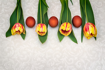 Image showing Three Easter eggs and tulips.
