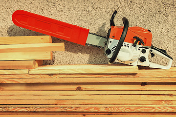 Image showing Chainsaw and lumber.