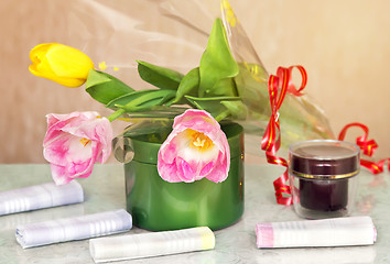 Image showing Cosmetics for body and hair and flowers.