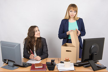 Image showing Office staff member with a smile watching fired colleague