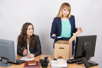 Image showing Office staff member with a smile watching charges fired colleagues